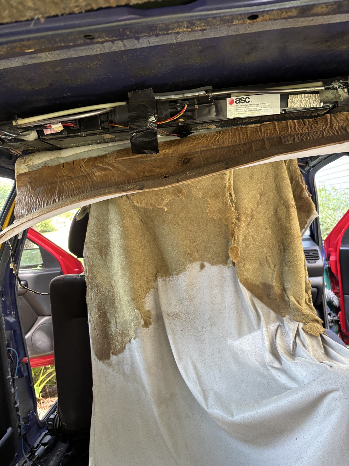 Harlequin interior with the headliner removed and sunroof mechanism exposed